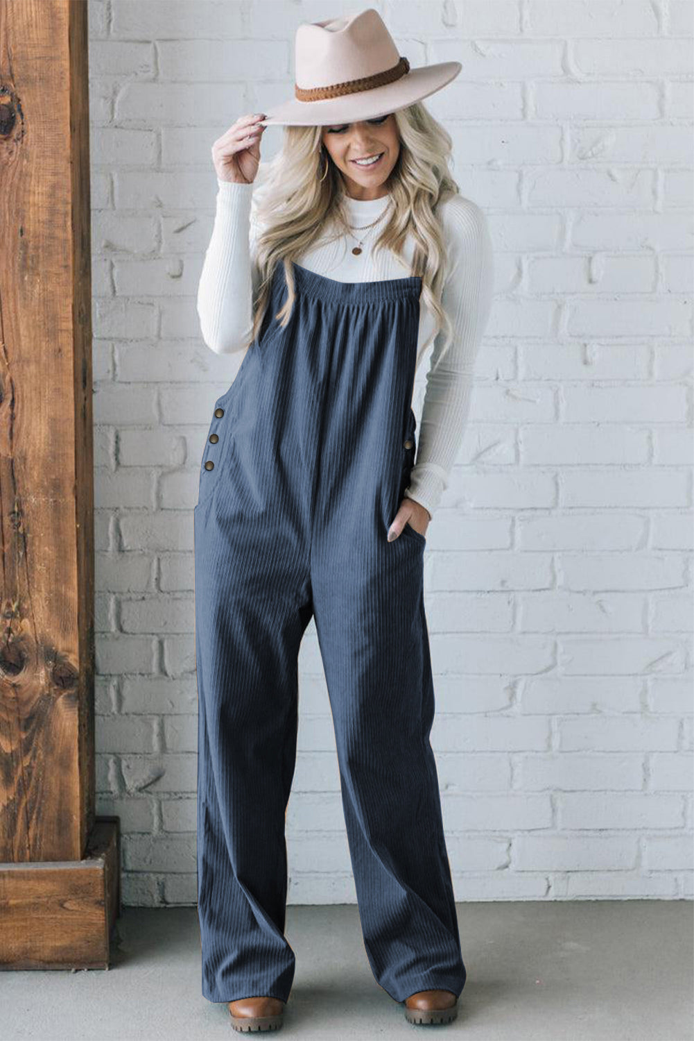 Black solid pocketed loose-fitting corduroy overall.