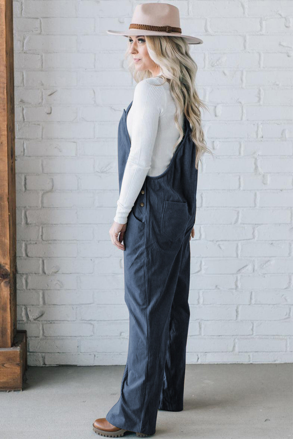 Black solid pocketed loose-fitting corduroy overall.