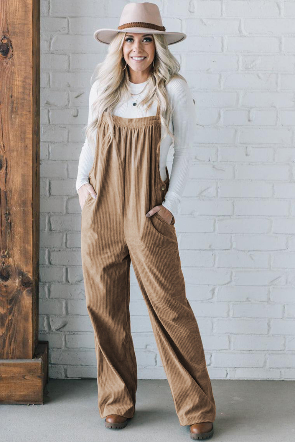 Black solid pocketed loose-fitting corduroy overall.