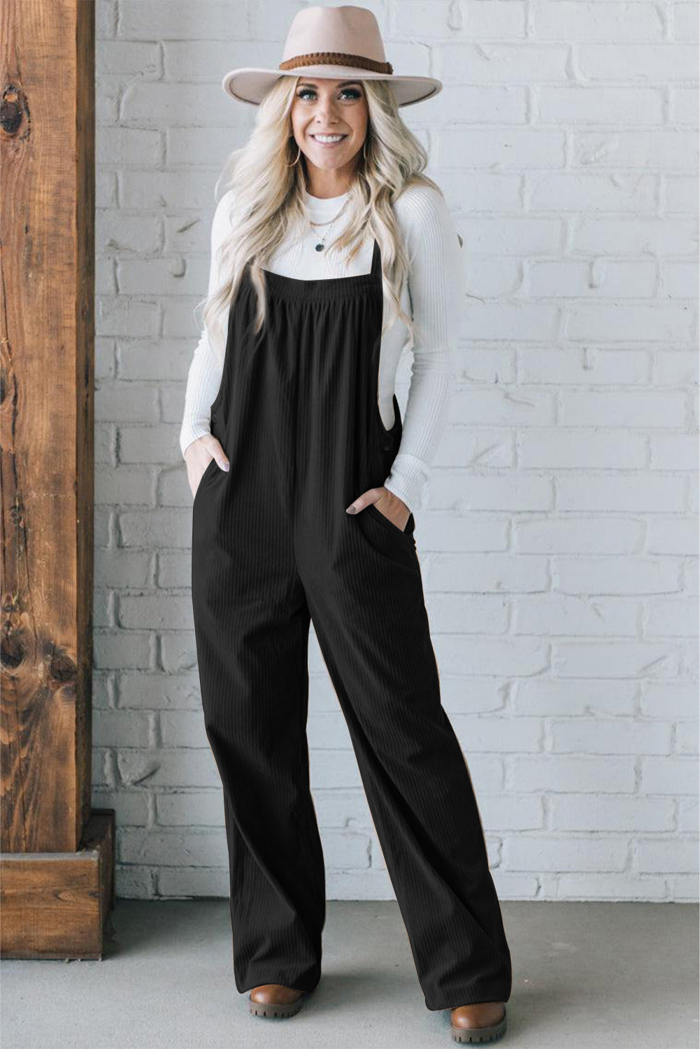 Black solid pocketed loose-fitting corduroy overall.