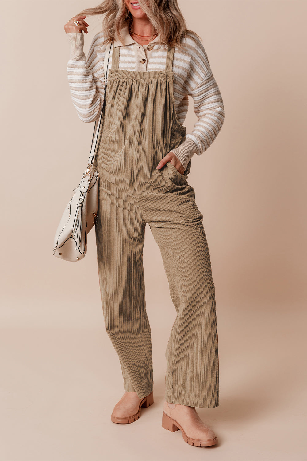 Black solid pocketed loose-fitting corduroy overall.