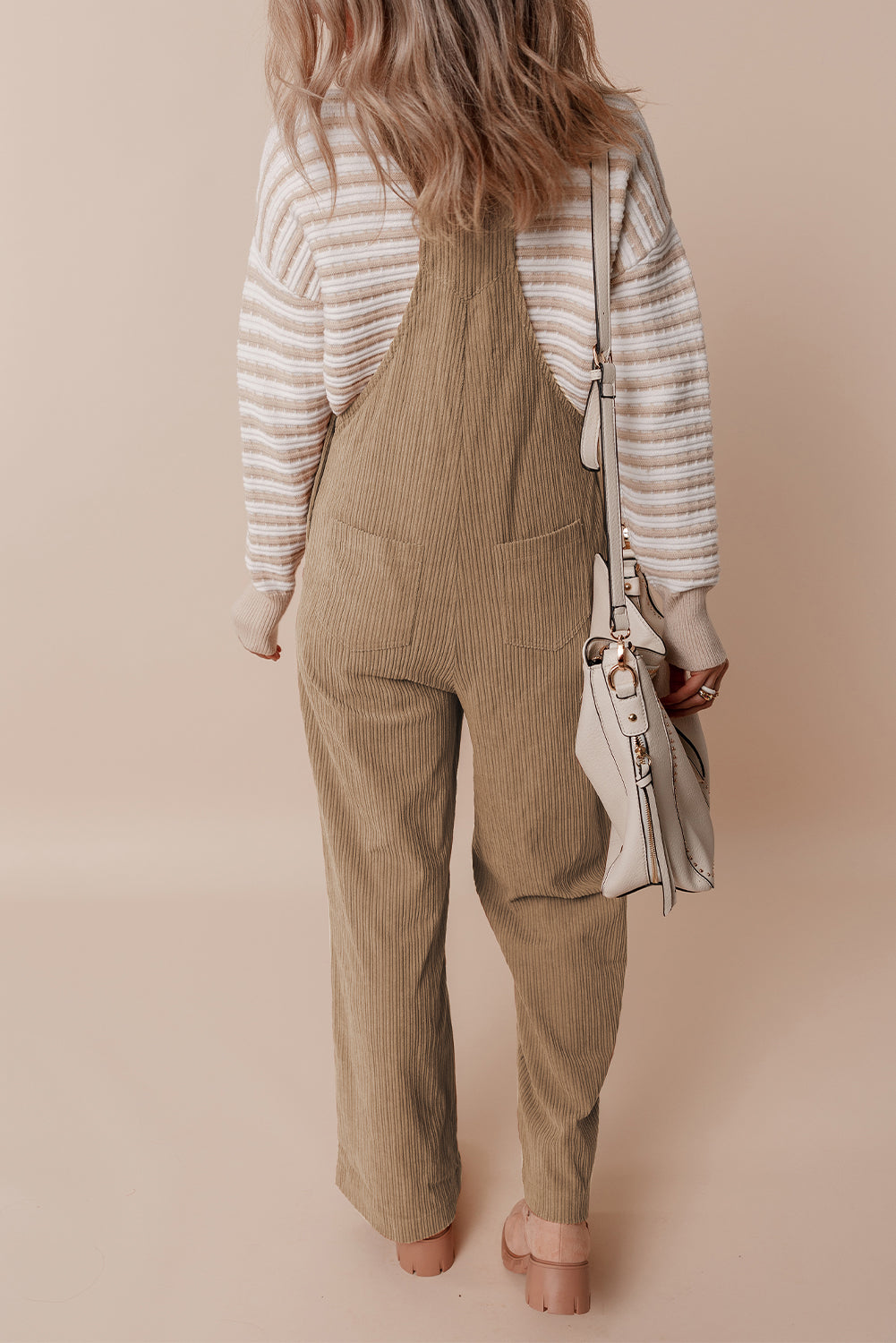 Black solid pocketed loose-fitting corduroy overall.