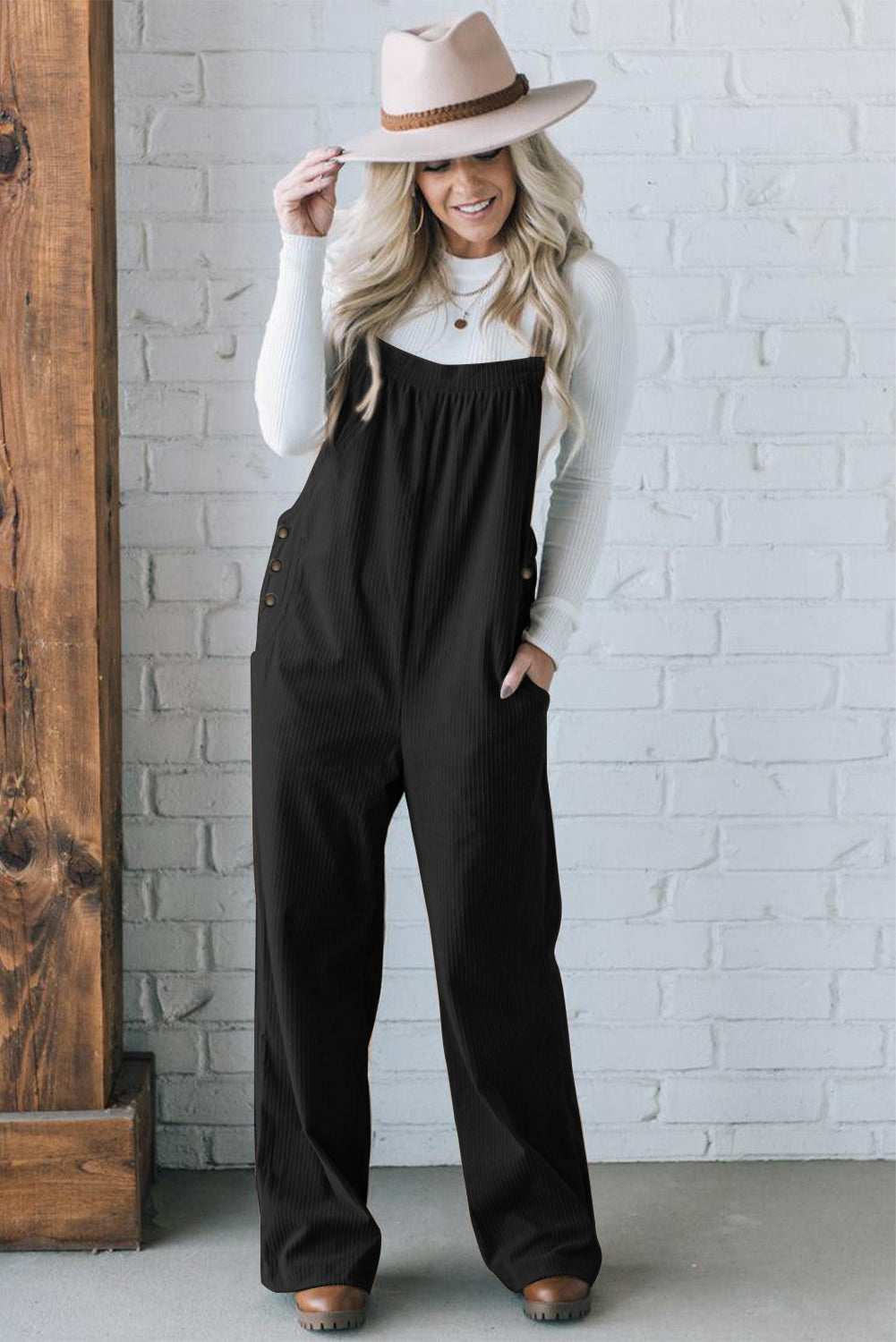 Black solid pocketed loose-fitting corduroy overall.