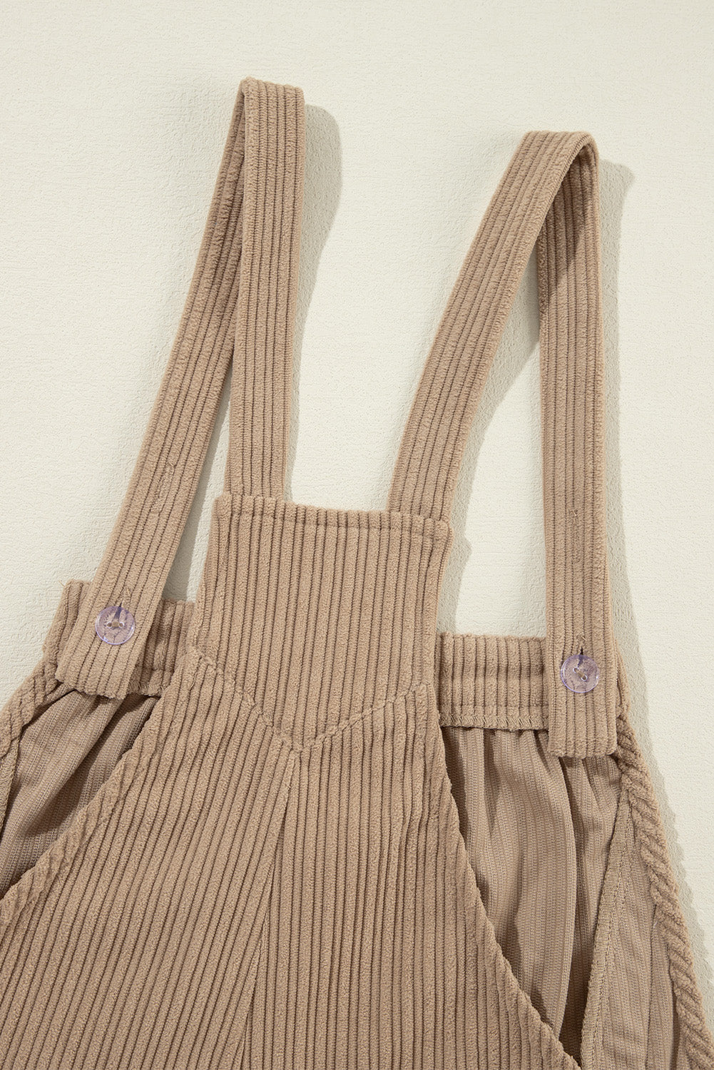 Black solid pocketed loose-fitting corduroy overall.