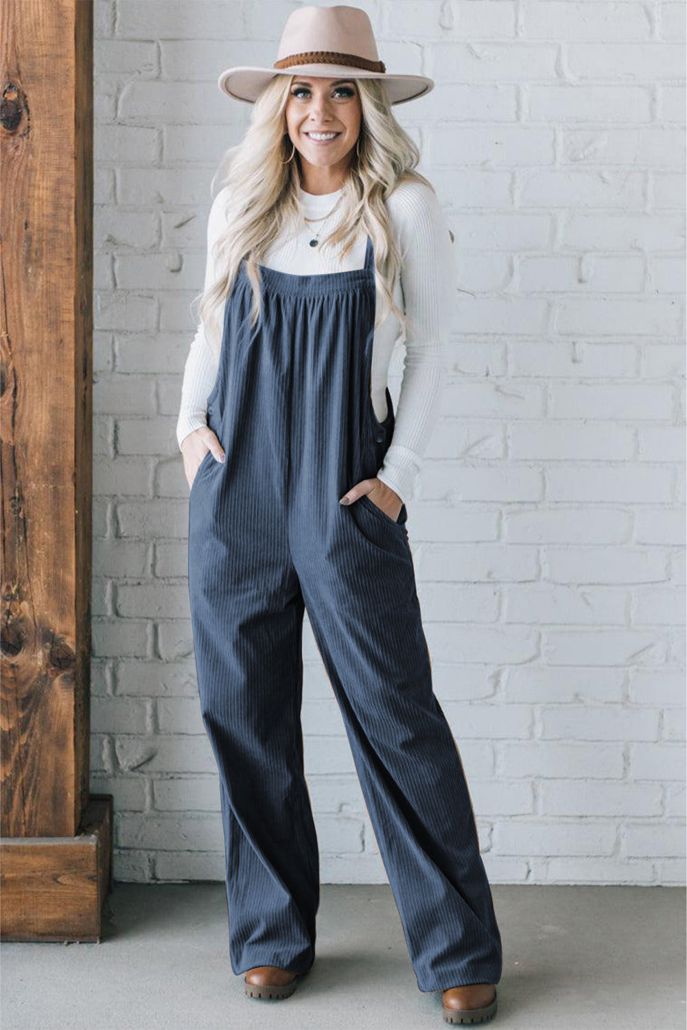 Black solid pocketed loose-fitting corduroy overall.