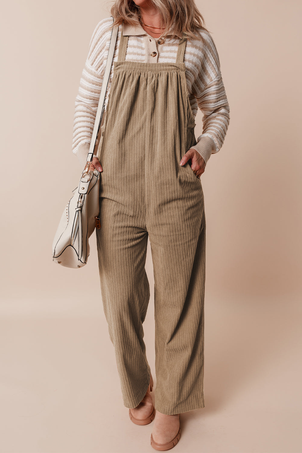 Black solid pocketed loose-fitting corduroy overall.